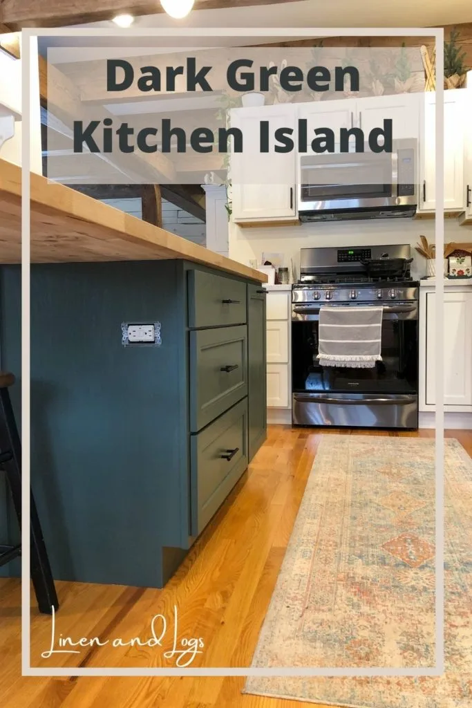 dark green kitchen island with butcher block countertop and white cabinets in kitchen