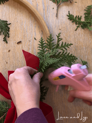adding branches to embroidery hoop wreath