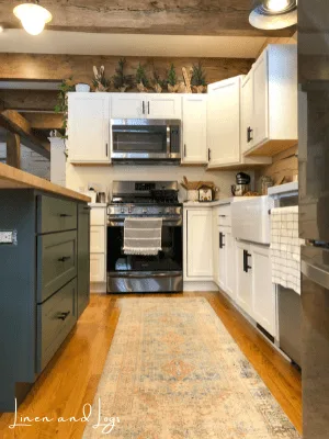dark green cabinet with drawers and wood countertop