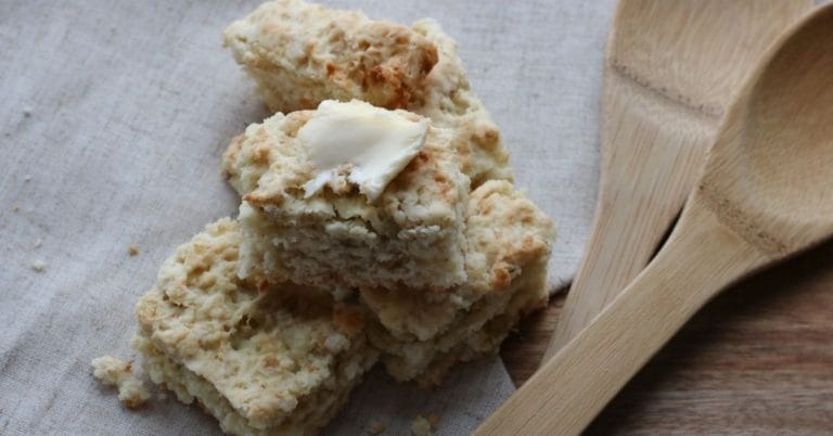 Rieska Bread with butter on cloth with wooden spoons