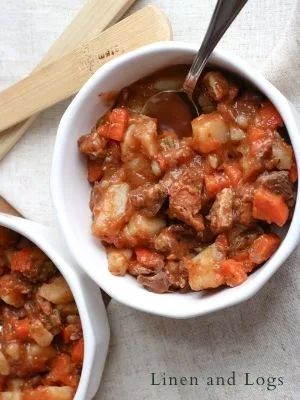 two white bowls with leftover roast beef stew made with beef broth