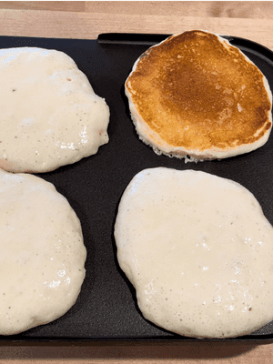flipping buttermilk pancakes on griddle