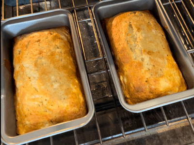 banana bread loaves in bread pans in the oven