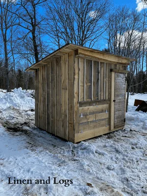 rough cut lumber chicken coop with exterior access to nesting boxes