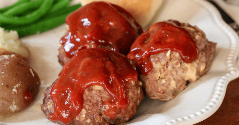 baked bbq meatballs with bbq sauce on top and green bean side