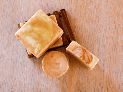 stacked and standing bars of sweet orange and rosemary tallow soap bars