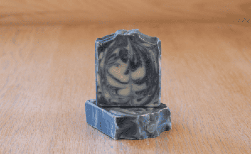 two bars of superior stone soap made with tallow, activated charcoal, and bentonite clay