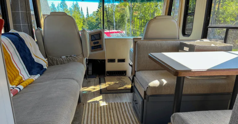 Class A Motorhome Renovation viewing RV couch, dinette and cockpit areas.