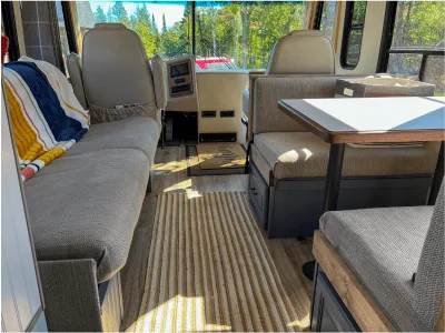 RV cabin space with couch, dinette, and cockpit area